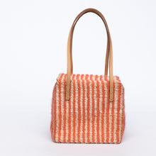 Load image into Gallery viewer, Pumpkin-colored Dolly Cube Handbag, handwoven with natural plant fibers and acrylic yarn, featuring sturdy cow leather handles and magnetic closures.