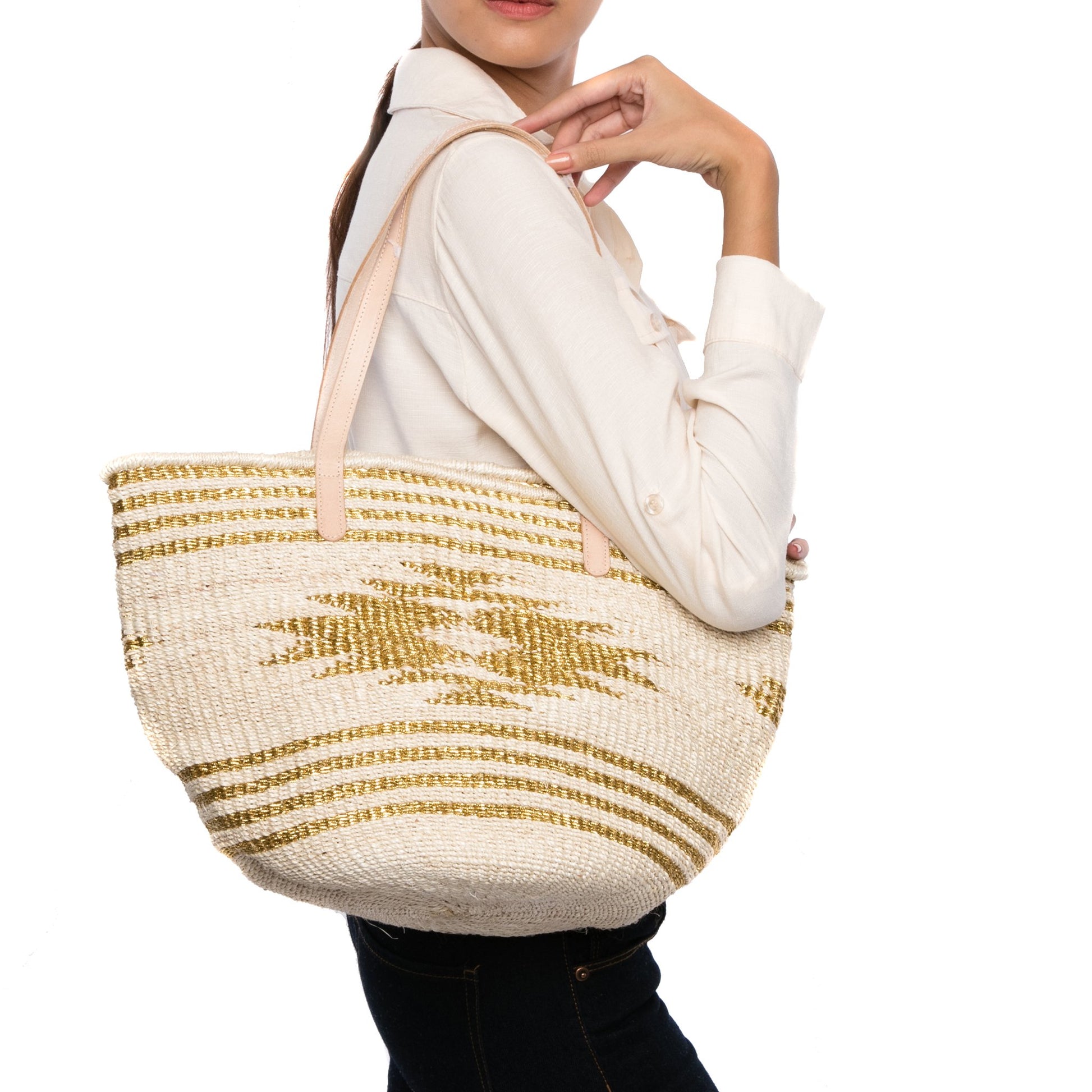 Golden Eagle Tote – Versatile handwoven natural plant fiber tote with Vachetta leather handles, ideal for beach days, shopping trips, and city outings.