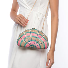 Load image into Gallery viewer, Seashell Karuna Rainbow Clutch, hand-loomed raffia body with hand embroidery, adorned with freshwater pearls wrapped in brass, and a versatile brass drop-in chain strap.