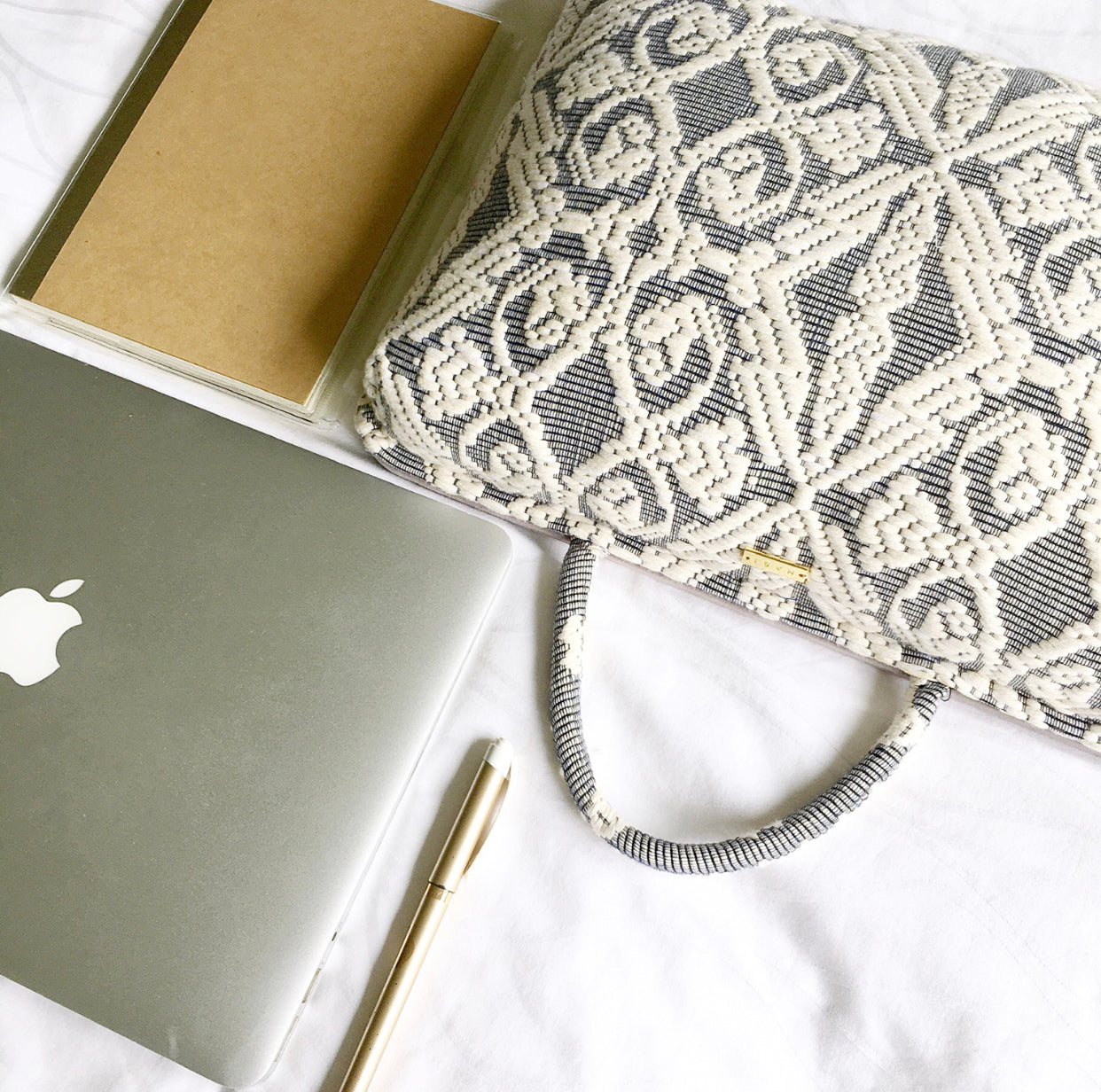 Hazel Inabel Laptop Pillow made from traditional Abel Iloco handloomed fabric with a faux suede non-slip top and convenient handle for easy portability.