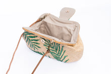 Load image into Gallery viewer, Palm Leaves Signature Larone Purse, handwoven from raffia with embroidered daisies and a rattan frame, featuring a leather strap for a sustainable, chic accessory.