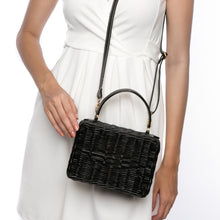 Load image into Gallery viewer, Serene Waters Wicker Bag made from handwoven rattan with an adjustable leather strap and cotton lining. Perfect for holding essentials with a chic and sustainable design.