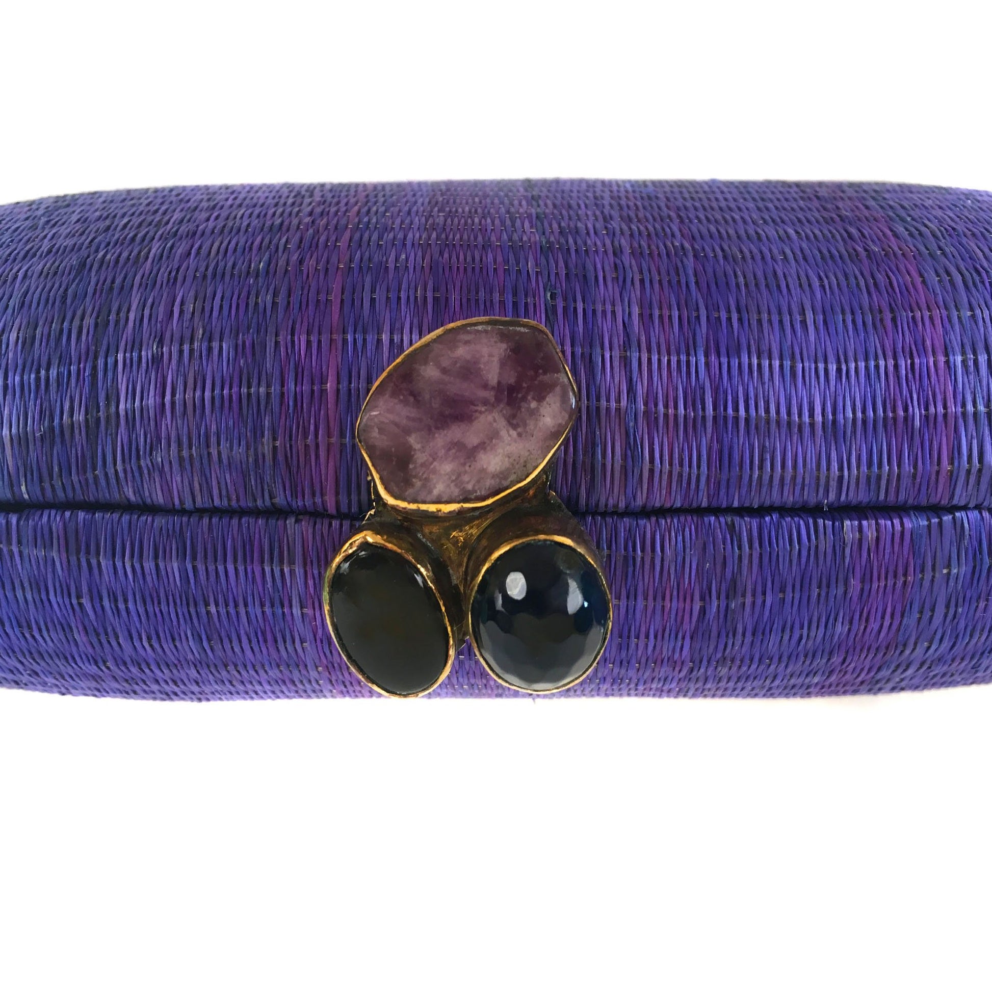 Still Waters Oval Hard Case Purse, handwoven from Buri plant fibers with agate stone accents and a brass chain strap for versatile carrying options.