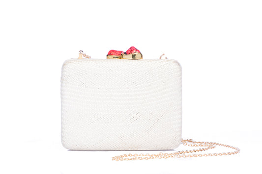 Iris White Woven Clutch made from sustainable plant fibers, featuring a bold red stone accent, brass drop-in chain strap, and fully lined interior for an eco-friendly yet elegant look.