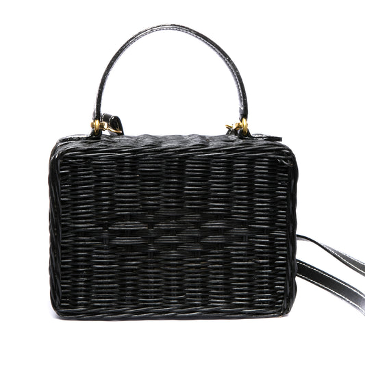 Serene Waters Wicker Bag made from handwoven rattan with an adjustable leather strap and cotton lining. Perfect for holding essentials with a chic and sustainable design.