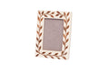 Decorative picture frame with leaf pattern on a white background