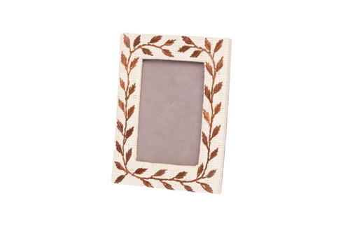 Decorative picture frame with leaf pattern on a white background
