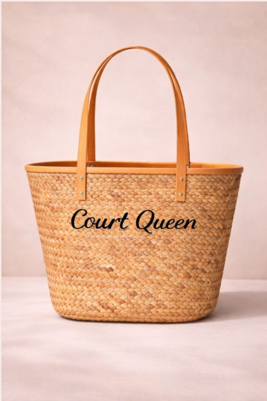 Woven bag with 'Court Queen' text on a beige background