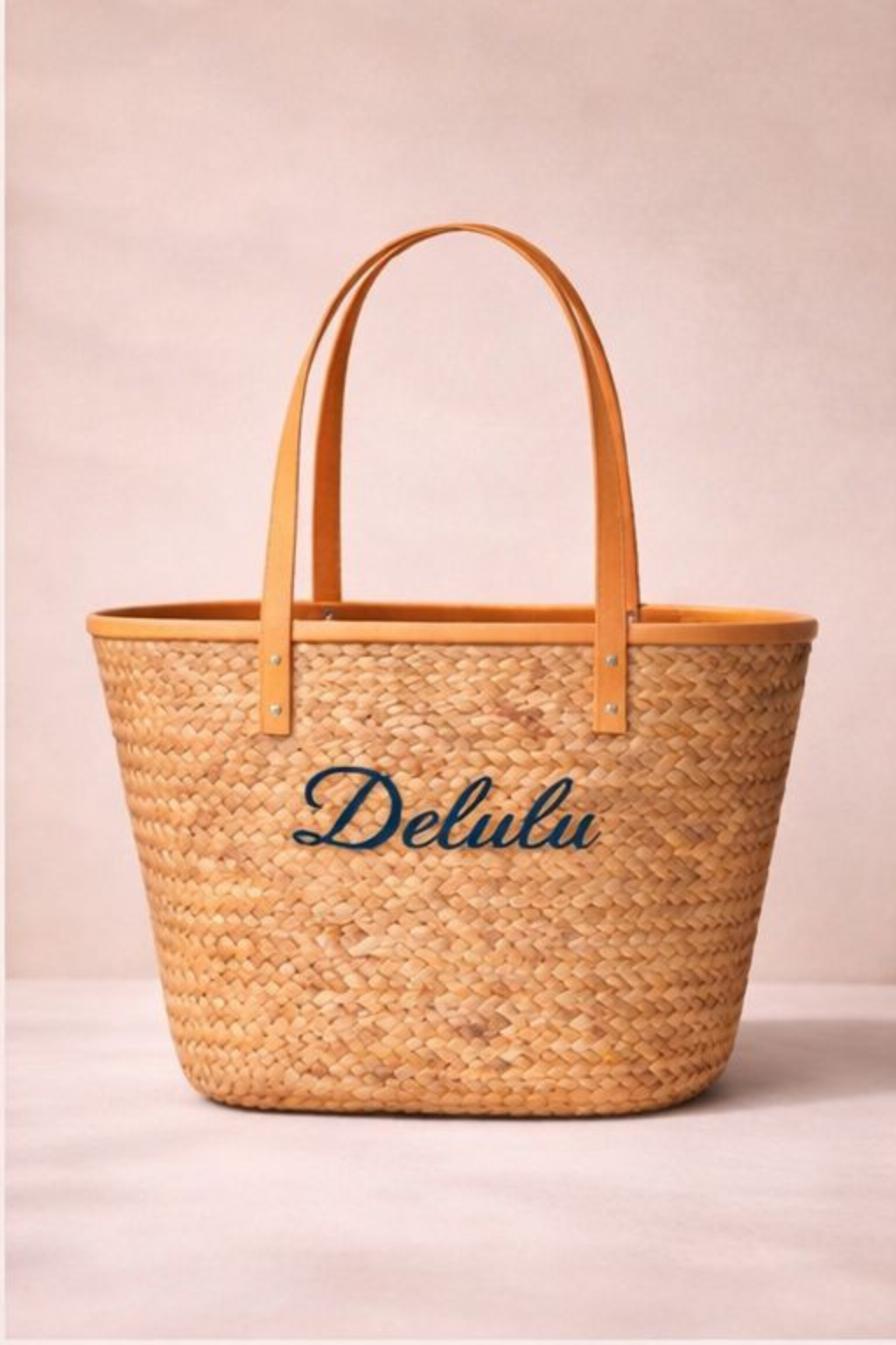 Woven bag with 'Delulu' branding on a beige background