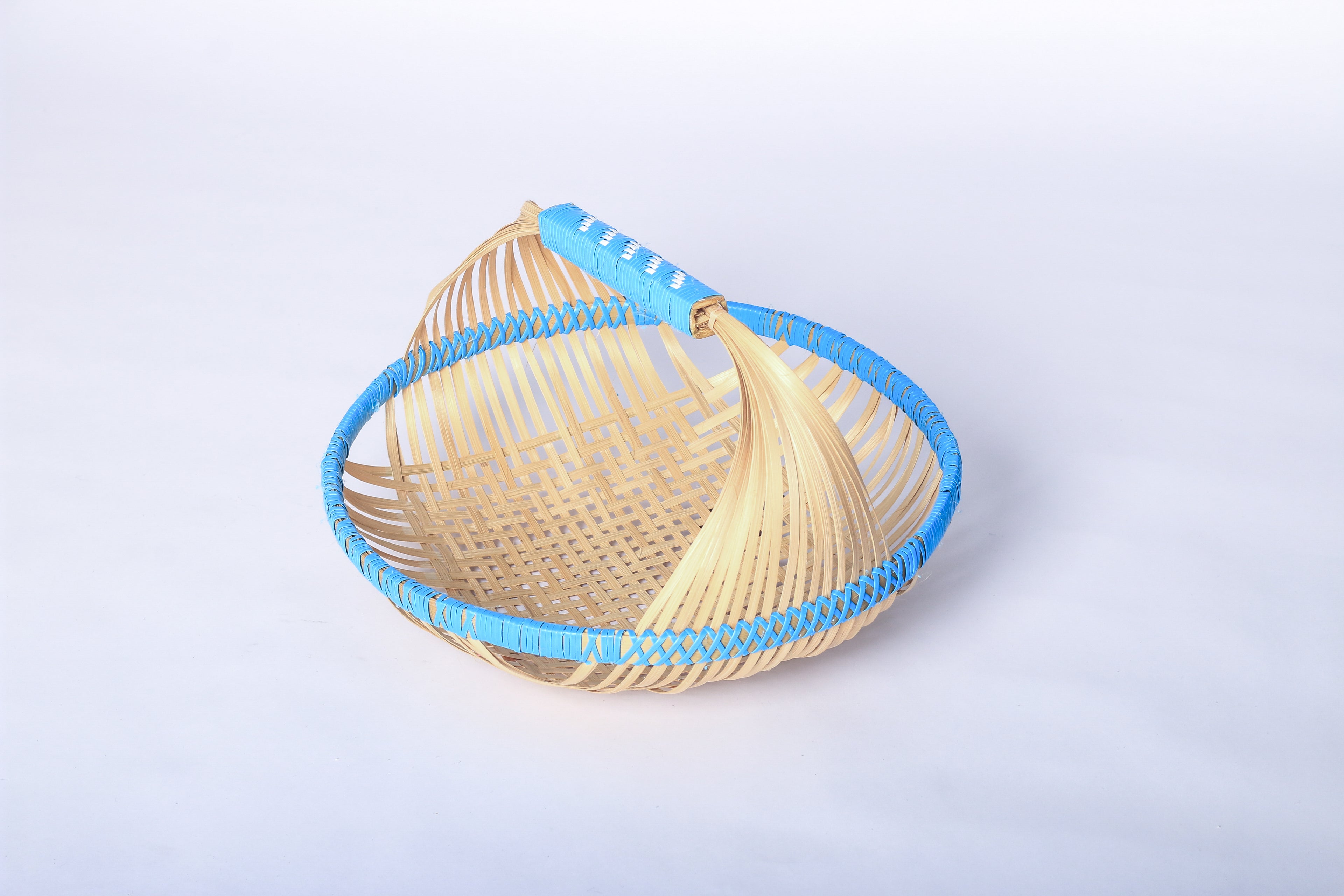 Blue Faustina Festive Fruit Basket with Handle, crafted from eco-friendly materials, perfect for carrying fresh produce, organizing kitchen essentials, or adding a decorative touch to your home. Features a sturdy handle and vibrant design for culinary adventures.