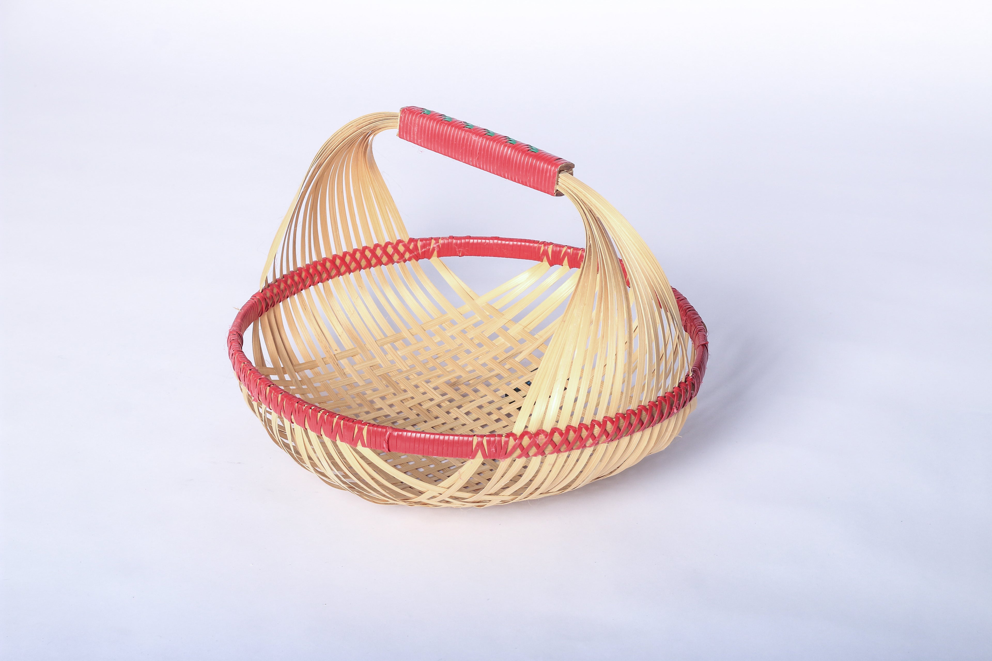 Red Faustina Festive Fruit Basket with Handle, crafted from eco-friendly materials, perfect for carrying fresh produce, organizing kitchen essentials, or adding a decorative touch to your home. Features a sturdy handle and vibrant design for culinary adventures.