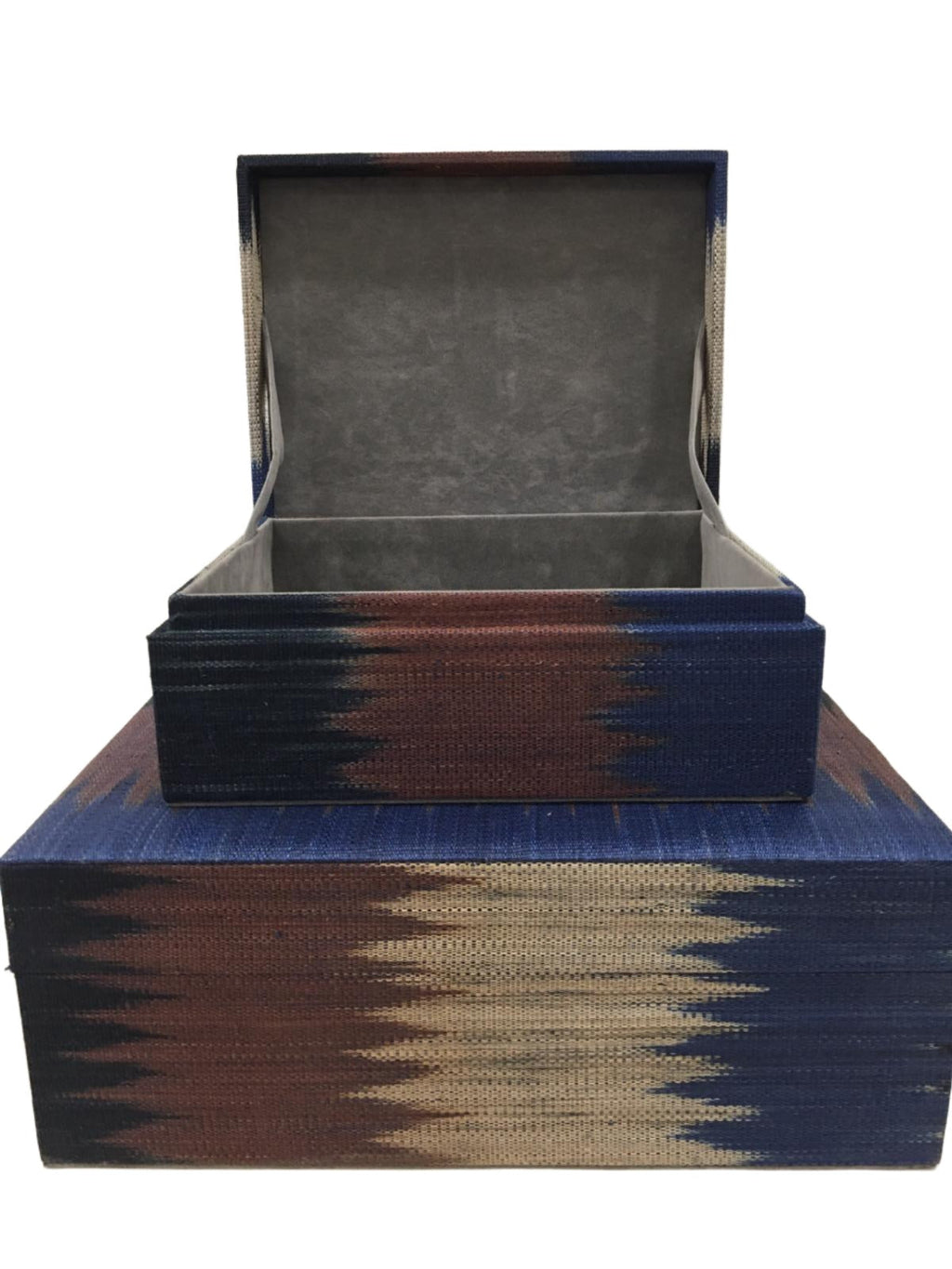 Zia Storage Boxes Set of 2 made from 100% natural plant fiber and adorned with tinalak, a handloomed fabric by the T'boli tribe. Featuring a faux suede lining, these eco-friendly storage boxes provide stylish organization and cultural elegance for any home.