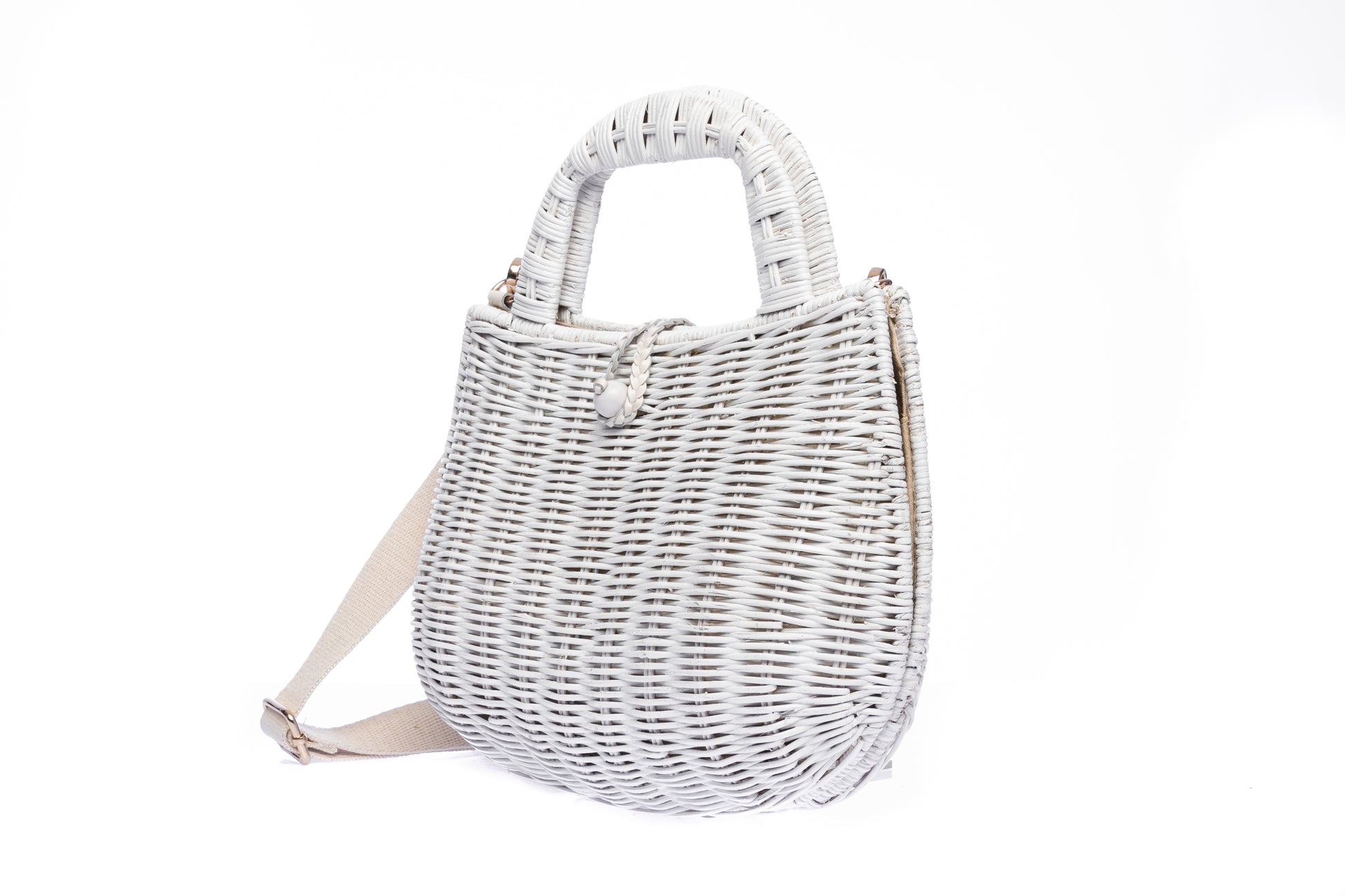 Handwoven Abi Wicker White Rattan Shoulder Bag with adjustable cotton strap and brass hardware, made by artisans in the Philippines. Sustainable and stylish.