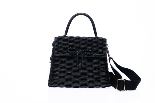 Adie wicker black shoulder bag, handwoven from sustainable rattan with a cotton strap and brass hardware, perfect for eco-conscious style.