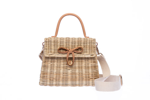Adie wicker natural shoulder bag, handwoven from sustainable rattan with a cotton strap and brass hardware, eco-friendly and stylish.