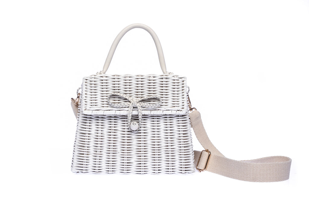 Adie wicker white shoulder bag, handwoven from sustainable rattan, featuring a cotton strap and brass hardware. Eco-friendly and stylish.
