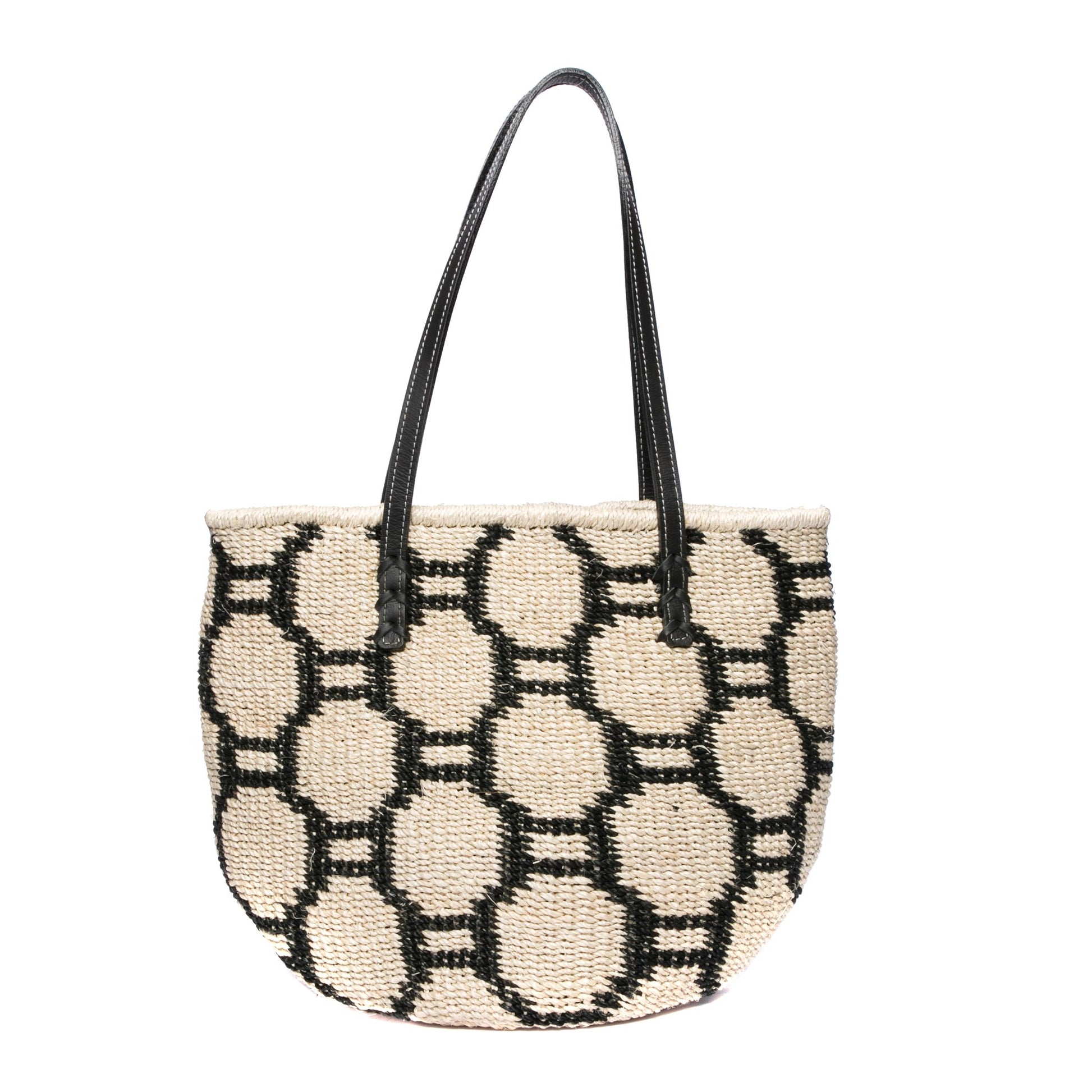 Beehive Tote Bag handwoven from natural plant fiber with leather handles and polka dot lining. Stylish and sustainable.