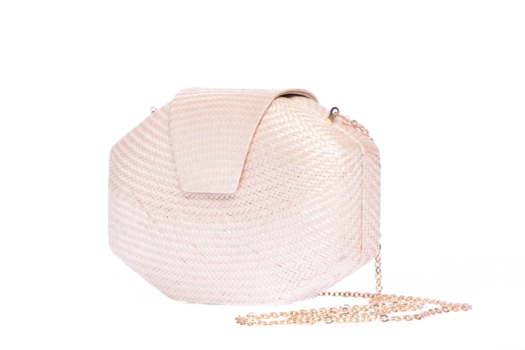 Blush pink wedding clutch made from sustainable plant fibers, featuring a brass chain strap and soft linen-cotton lining, perfect for brides and bridesmaids.
