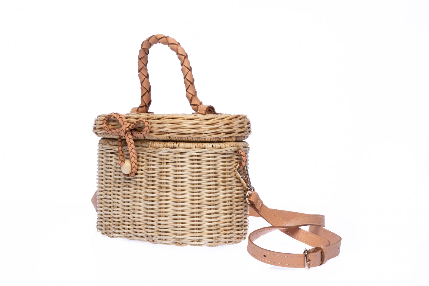 Camille Rattan Shoulder Bag made from handwoven rattan with adjustable leather strap and brass hardware. Eco-friendly and stylish design for any occasion.