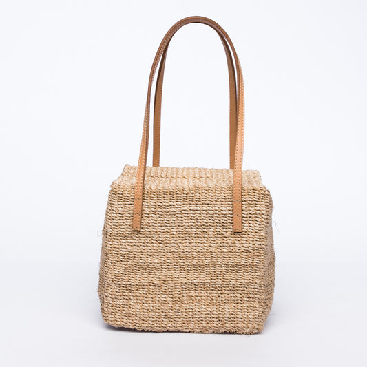 Dolly Cube Handbag with a unique cube shape, handwoven from natural plant fibers with cow leather handles, perfect for stylish city outings.