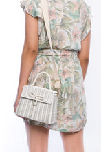Load image into Gallery viewer, Adie wicker white shoulder bag, handwoven from sustainable rattan, featuring a cotton strap and brass hardware. Eco-friendly and stylish.
