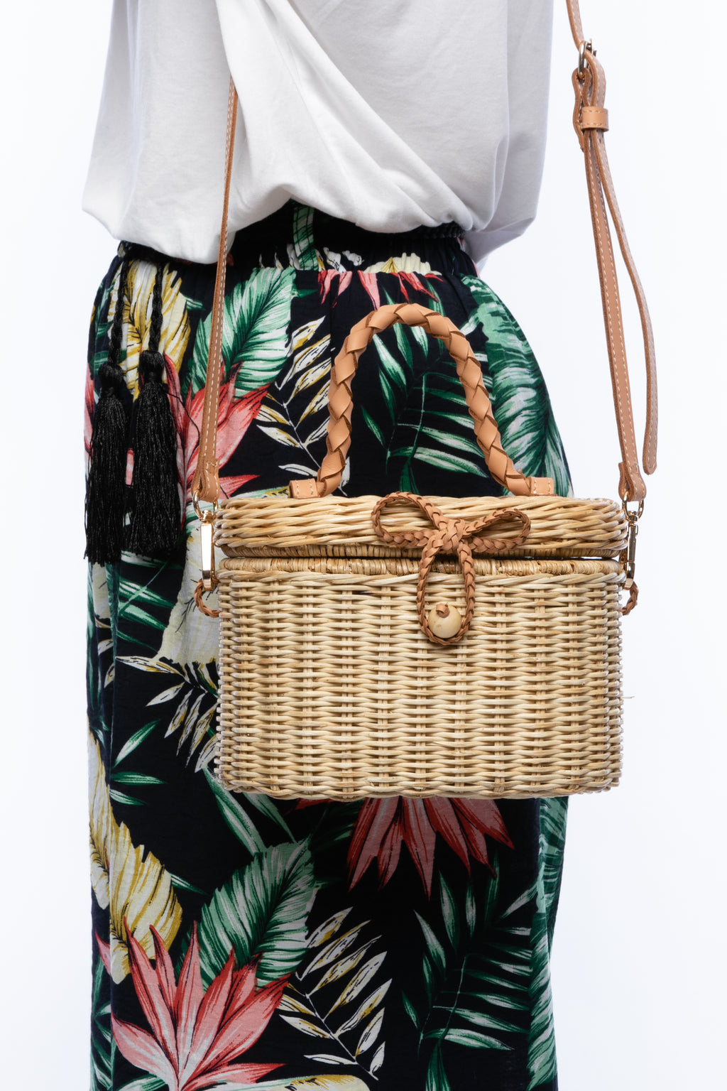 Camille Rattan Shoulder Bag made from handwoven rattan with adjustable leather strap and brass hardware. Eco-friendly and stylish design for any occasion.