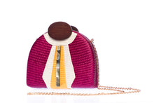 Load image into Gallery viewer, Gatsby Raspberry half-moon clutch made from handwoven natural plant fibers with a cracked sea shell bar and a brass chain strap, adding glamour and sophistication for any evening event.
