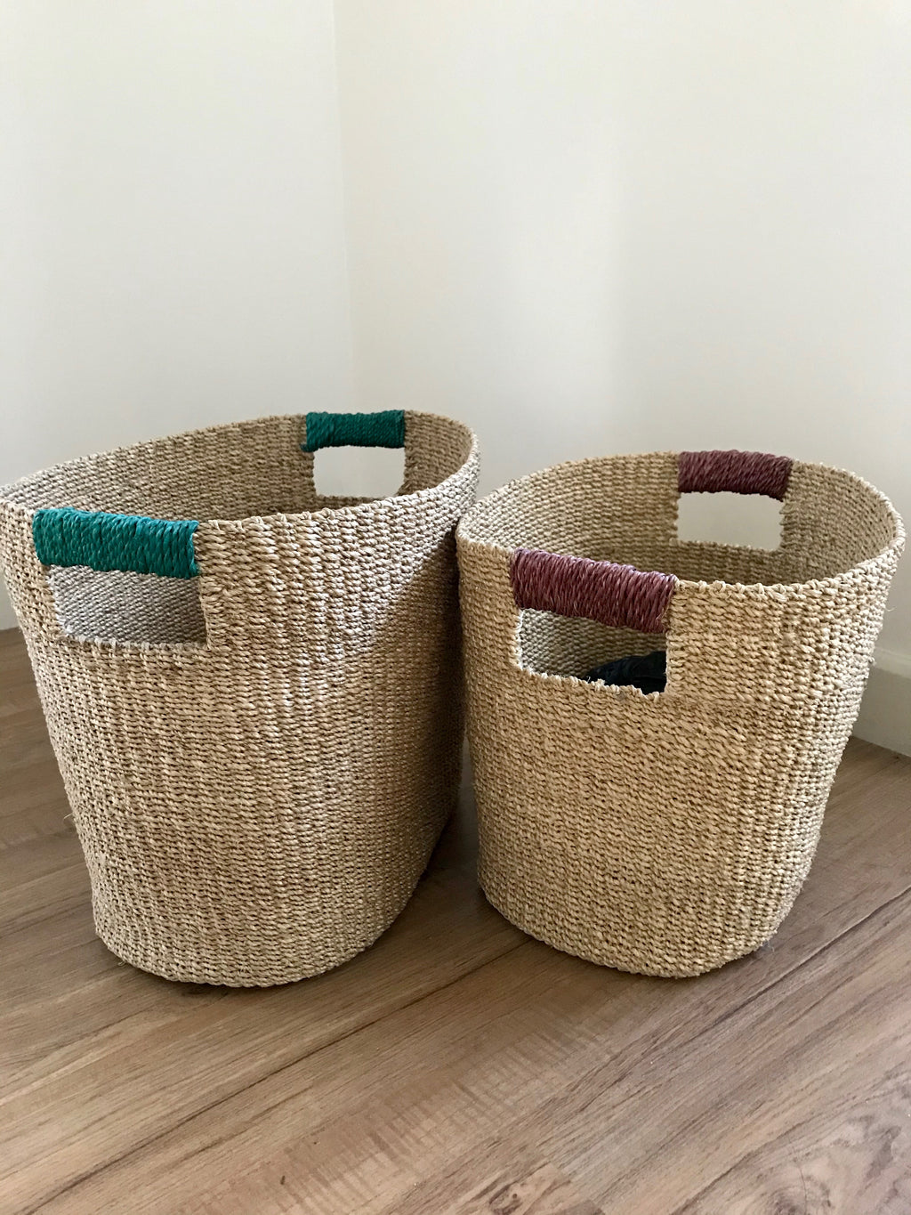 Ivy Oval Storage Baskets Set of 2, handcrafted from natural plant fibers, shown in small and large sizes for stylish and eco-friendly home organization.