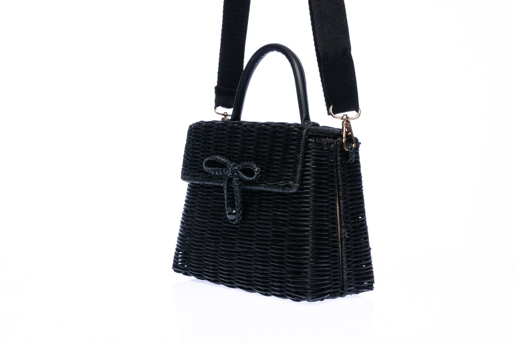 Adie wicker black shoulder bag, handwoven from sustainable rattan with a cotton strap and brass hardware, perfect for eco-conscious style.