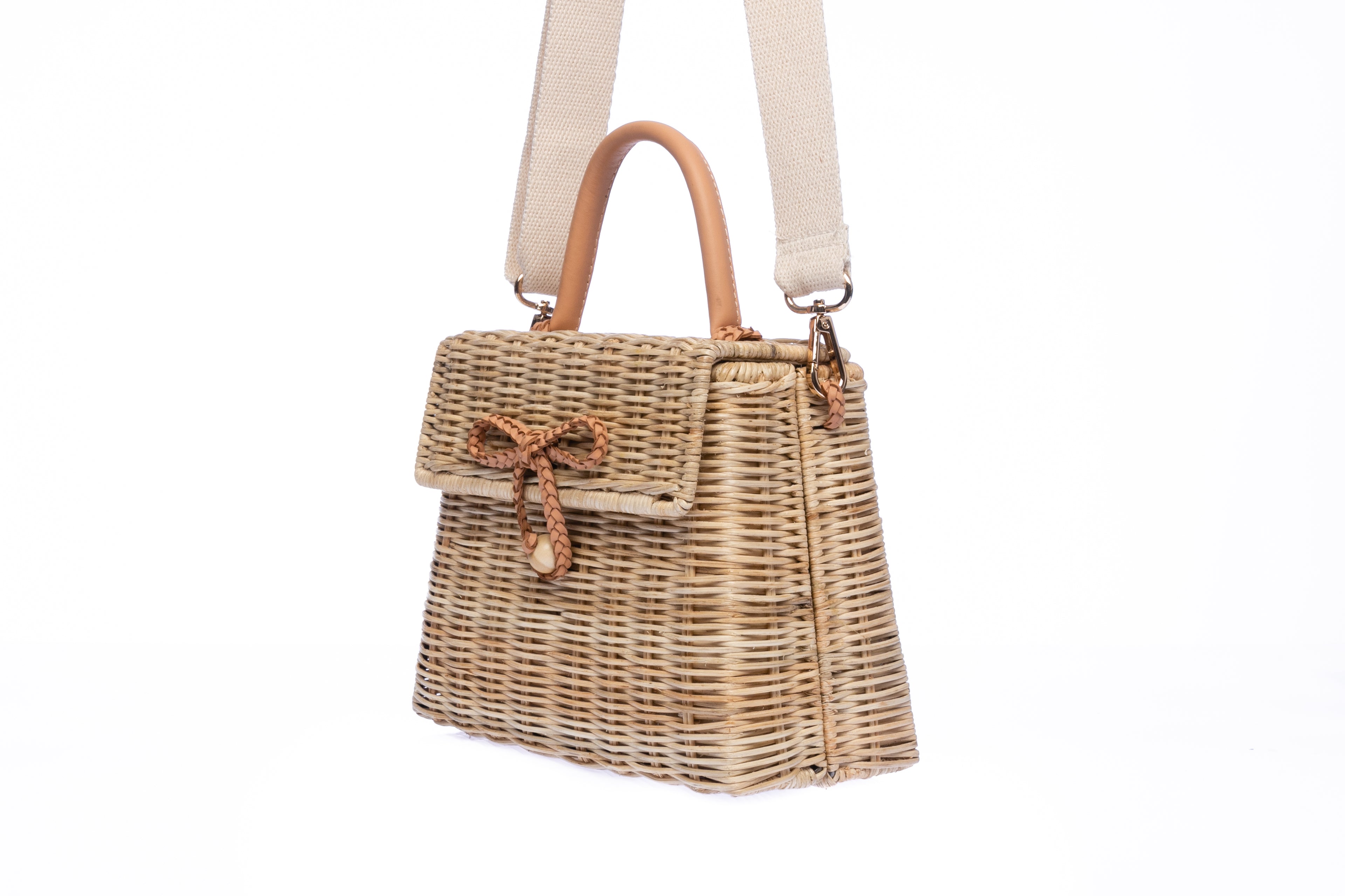 Adie wicker natural shoulder bag, handwoven from sustainable rattan with a cotton strap and brass hardware, eco-friendly and stylish.