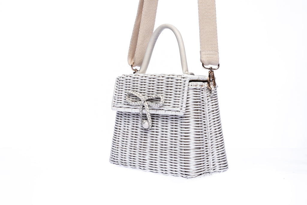 Adie wicker white shoulder bag, handwoven from sustainable rattan, featuring a cotton strap and brass hardware. Eco-friendly and stylish.