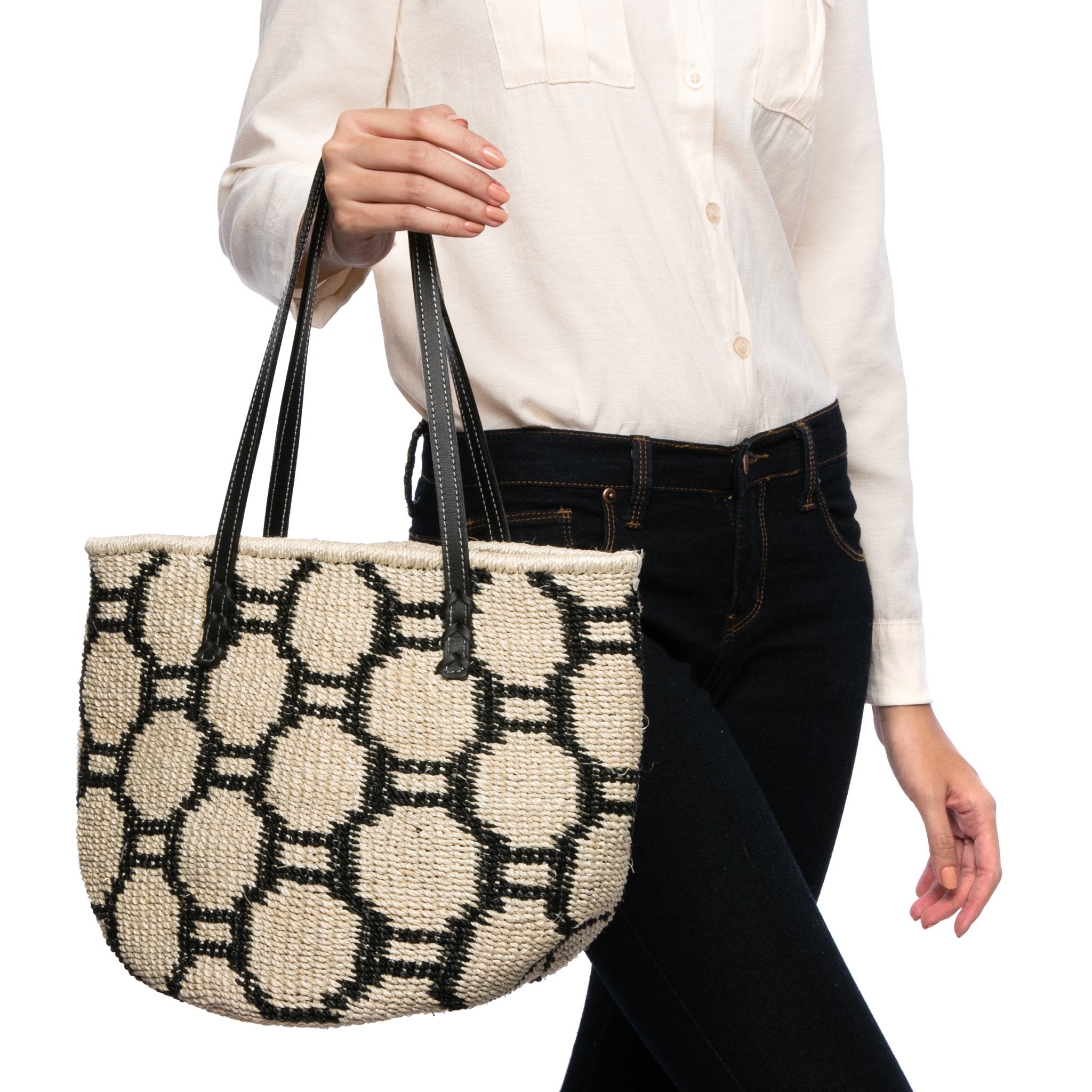 Beehive Tote Bag handwoven from natural plant fiber with leather handles and polka dot lining. Stylish and sustainable.