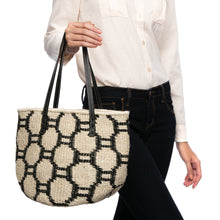 Load image into Gallery viewer, Beehive Tote Bag handwoven from natural plant fiber with leather handles and polka dot lining. Stylish and sustainable.
