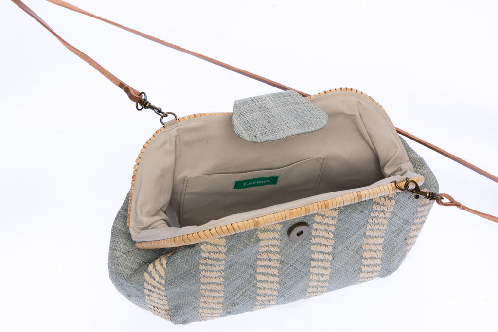 Grey Skye Signature Clutch – Handwoven raffia and rattan clutch with hand embroidery, featuring a removable leather strap for versatile styling.