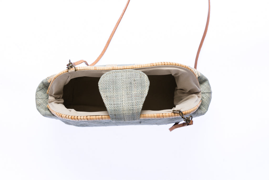 Grey Skye Signature Clutch – Handwoven raffia and rattan clutch with hand embroidery, featuring a removable leather strap for versatile styling.