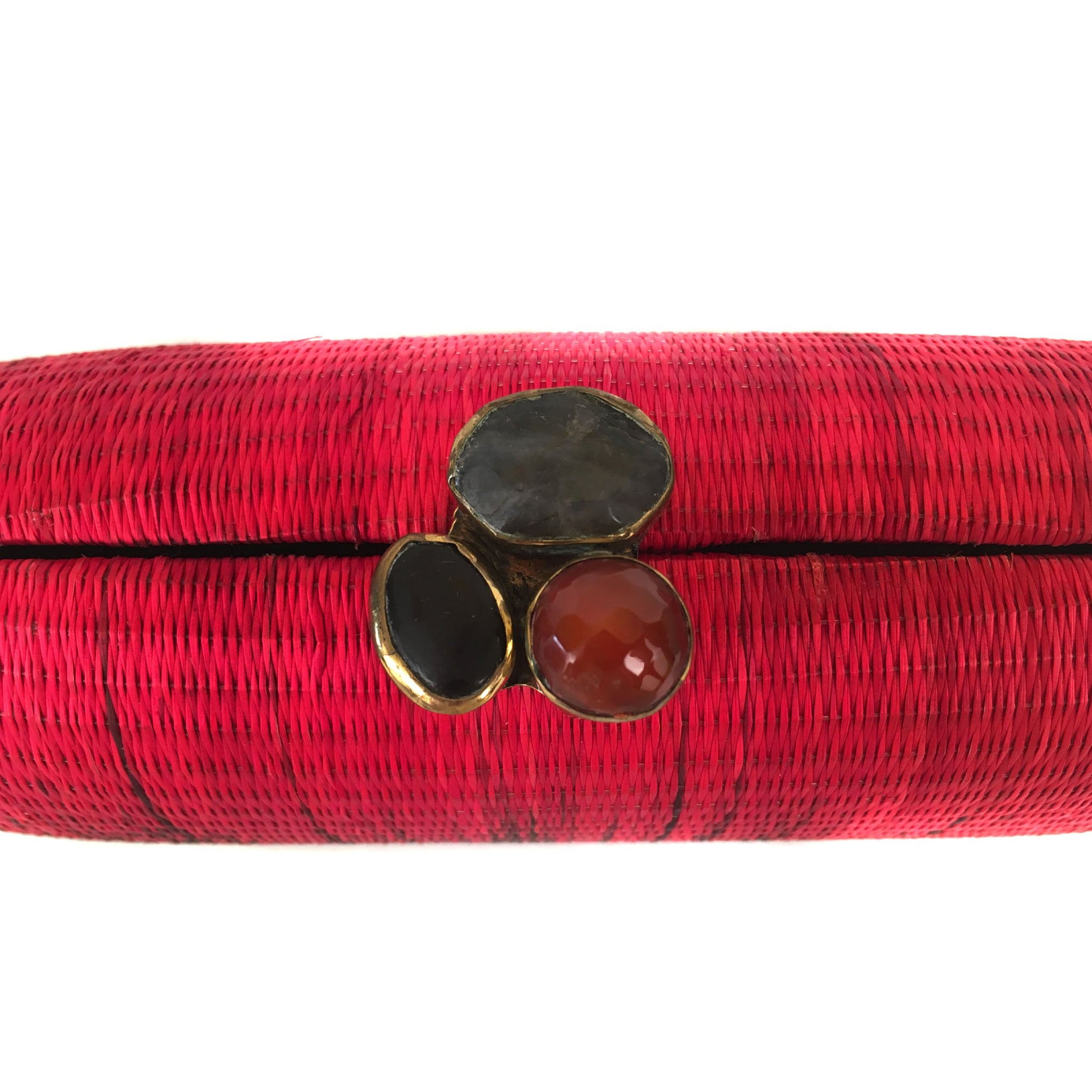 Horizon oval hard case purse handwoven from natural plant fibers, featuring agate stone accents wrapped in brass, a twill lining, and a brass drop-in chain for versatile wear.