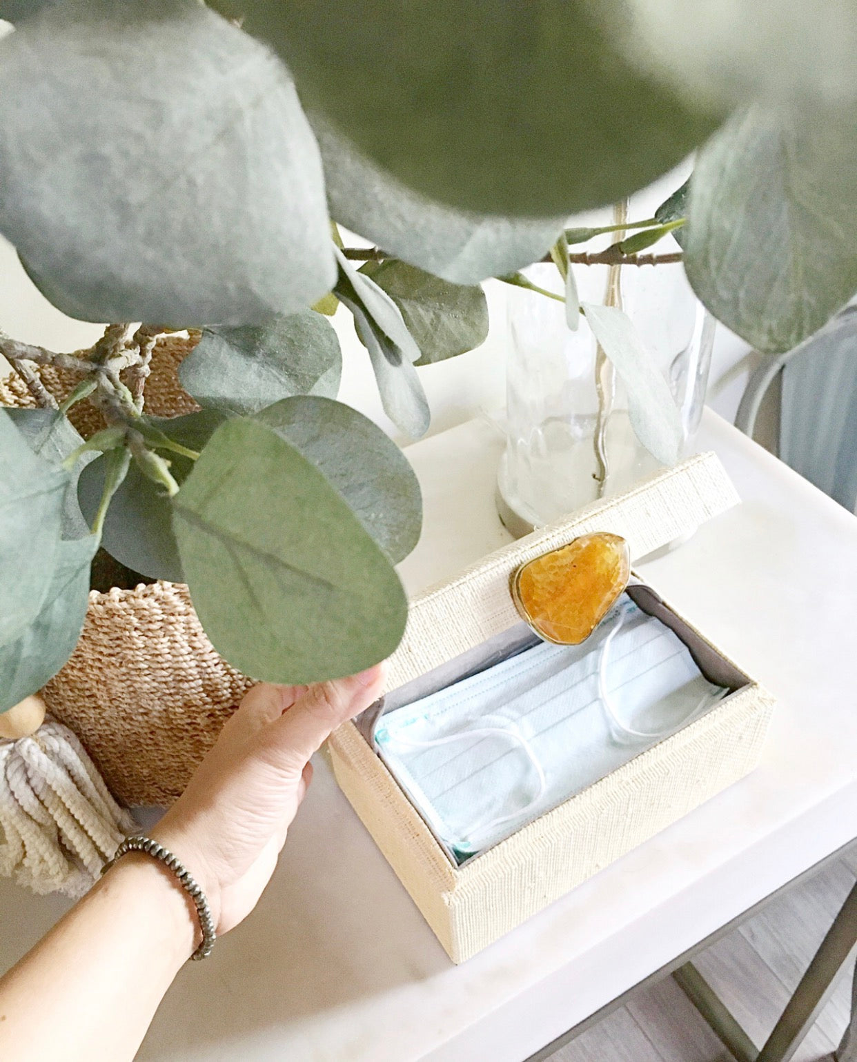 Karuna Raffia Jewelry Box crafted from handwoven natural plant fiber raffia with an agate stone accent capped in hand-tooled brass, perfect for stylish and eco-friendly jewelry storage.