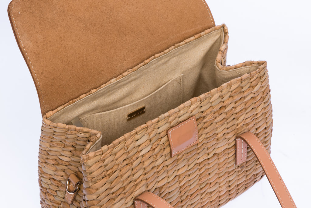 Maya Minimalist Shoulder Bag, handwoven from seagrass with genuine leather handles, flap, and shoulder straps. Designed to complement any outfit with natural elegance.