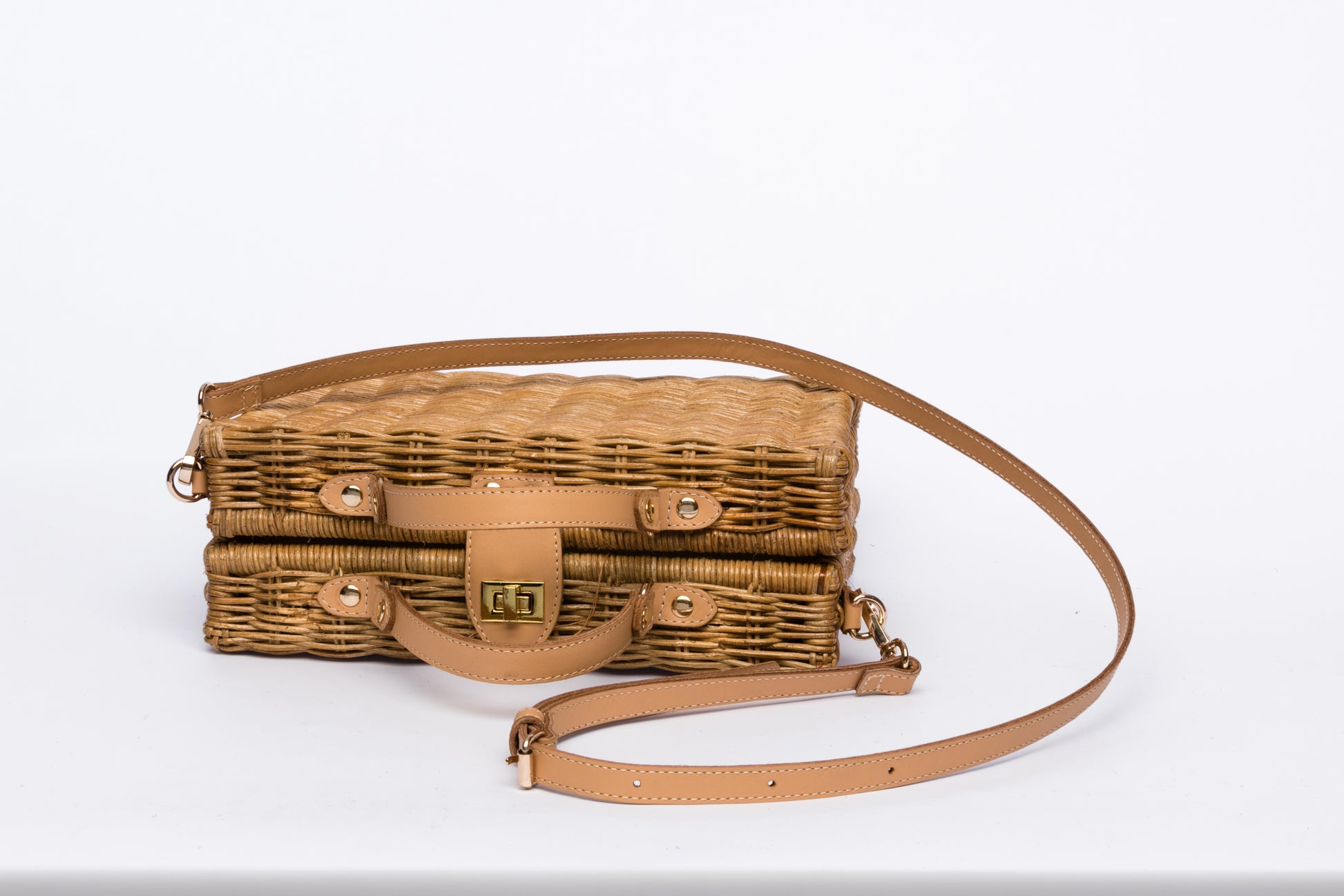 Mio Wicker Rattan Lunchbox with leather crossbody strap, handwoven from sustainable rattan, featuring clean lines and a minimalist design.