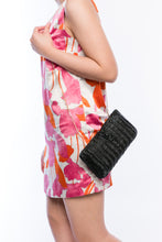 Load image into Gallery viewer, Myra Wicker Clutch Black handwoven from rattan with a brass chain strap and lined with linen and cotton, perfect for both day and night wear.
