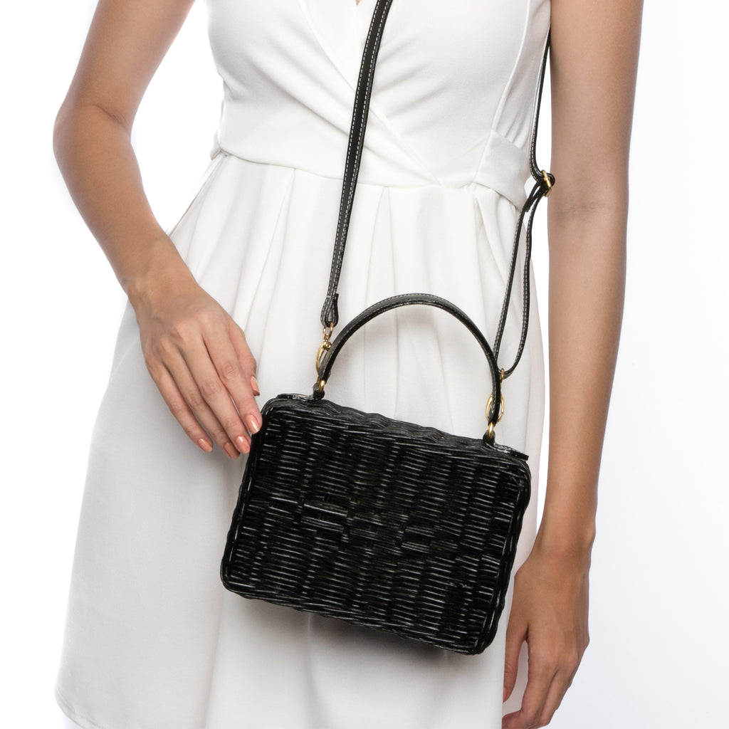 Serene Waters Wicker Bag made from handwoven rattan with an adjustable leather strap and cotton lining. Perfect for holding essentials with a chic and sustainable design.