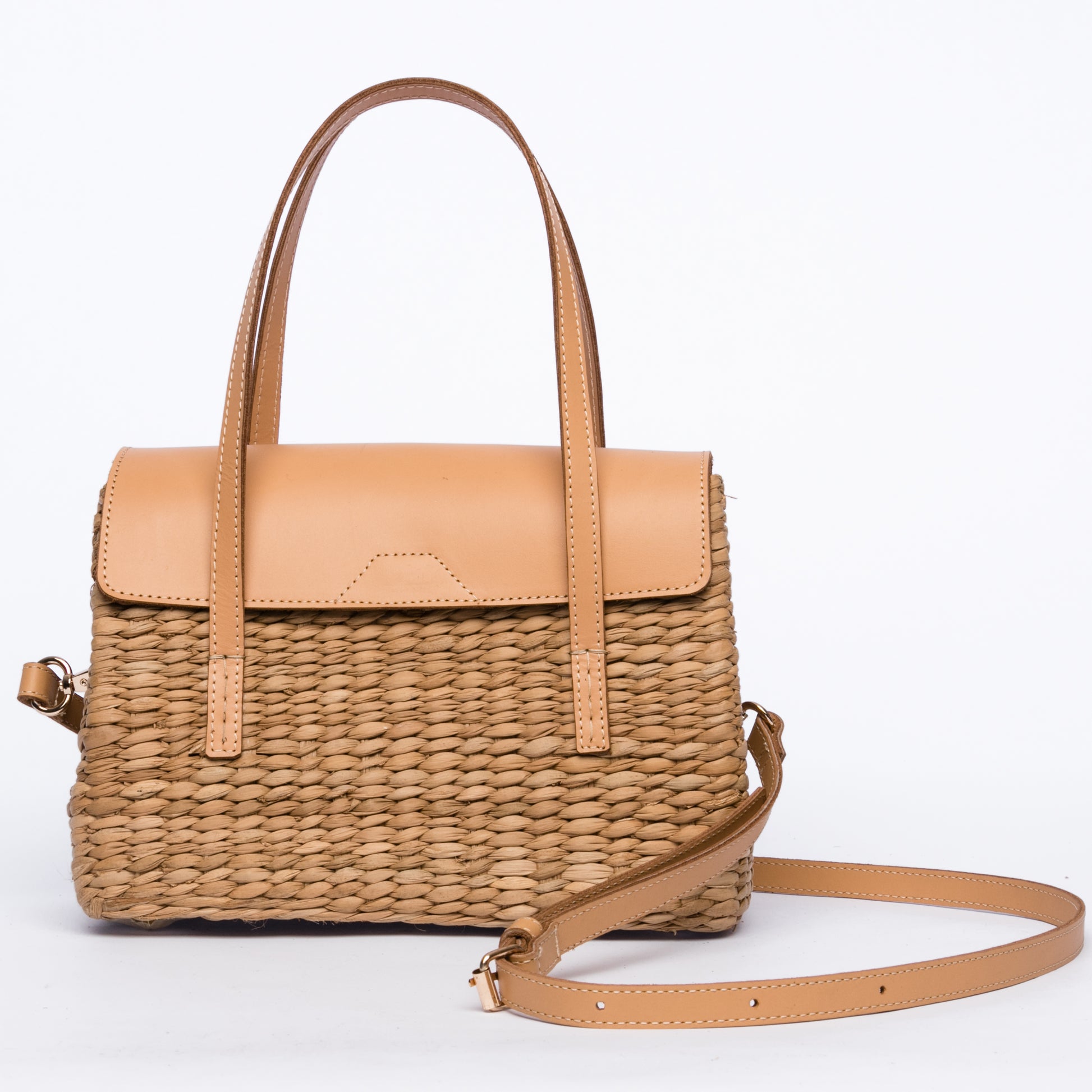 Maya Minimalist Shoulder Bag, handwoven from seagrass with genuine leather handles, flap, and shoulder straps. Designed to complement any outfit with natural elegance.