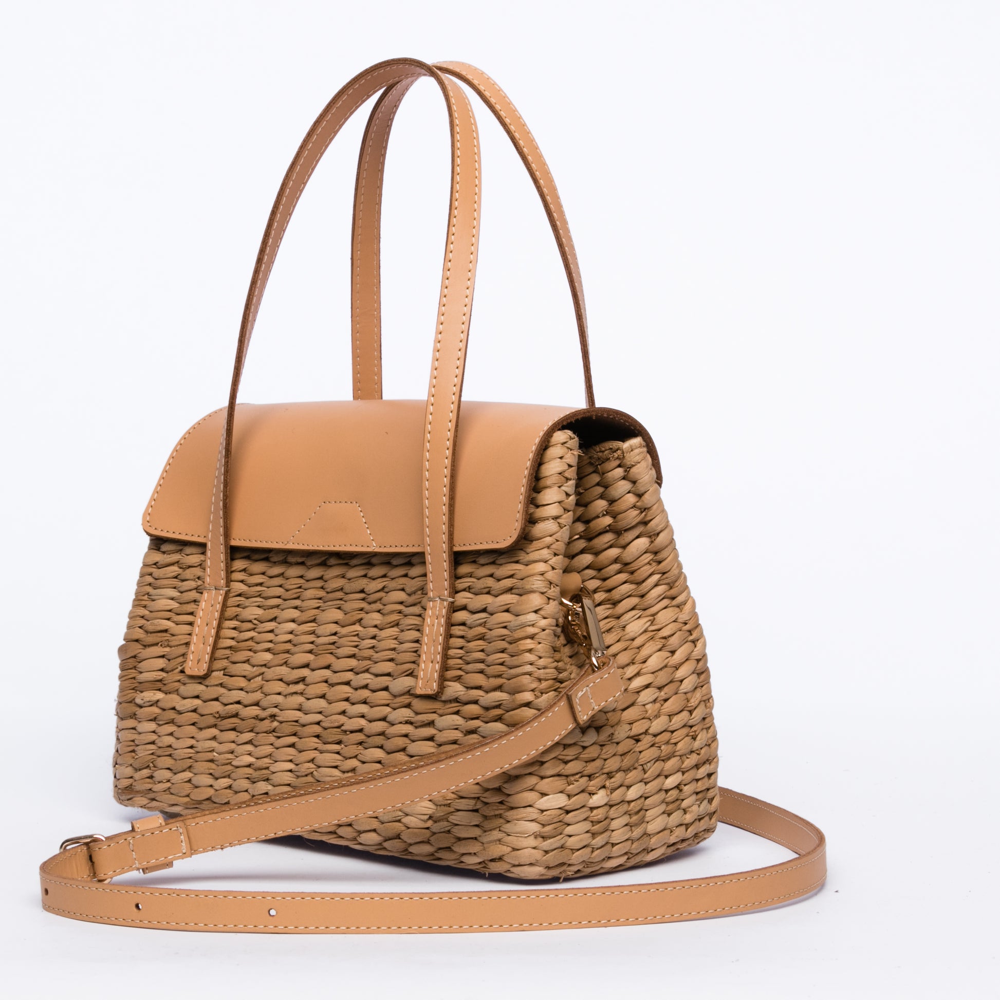 Maya Minimalist Shoulder Bag, handwoven from seagrass with genuine leather handles, flap, and shoulder straps. Designed to complement any outfit with natural elegance.