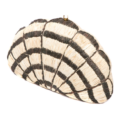 Seashell Karuna Clutch featuring hand-embroidered raffia fiber, freshwater pearls wrapped in brass, and a brass drop-in chain strap for versatility.