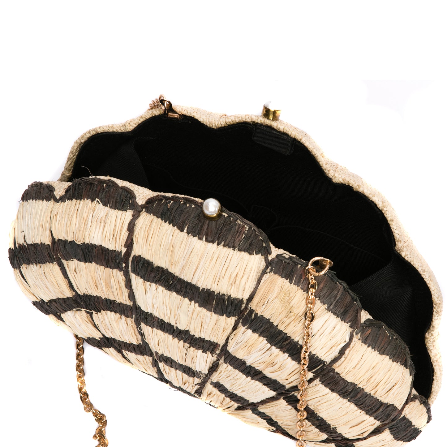 Seashell Karuna Clutch featuring hand-embroidered raffia fiber, freshwater pearls wrapped in brass, and a brass drop-in chain strap for versatility.