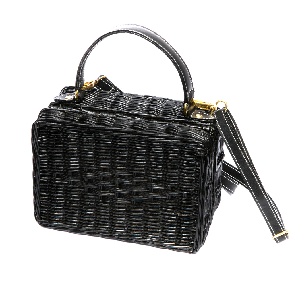 Serene Waters Wicker Bag made from handwoven rattan with an adjustable leather strap and cotton lining. Perfect for holding essentials with a chic and sustainable design.
