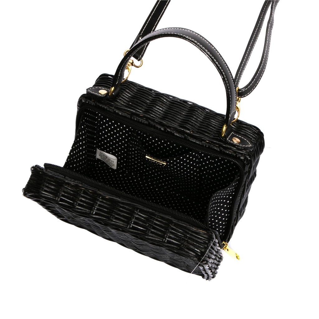 Serene Waters Wicker Bag made from handwoven rattan with an adjustable leather strap and cotton lining. Perfect for holding essentials with a chic and sustainable design.