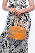 Load image into Gallery viewer, Pumpkin-colored Dolly Cube Handbag, handwoven with natural plant fibers and acrylic yarn, featuring sturdy cow leather handles and magnetic closures.
