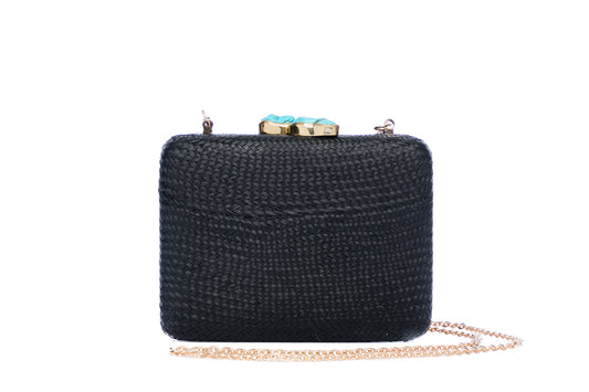 Iris Black Woven Clutch made from sustainable plant fibers, featuring a turquoise stone accent, brass drop-in chain strap, and fully lined interior for an eco-friendly and elegant look.