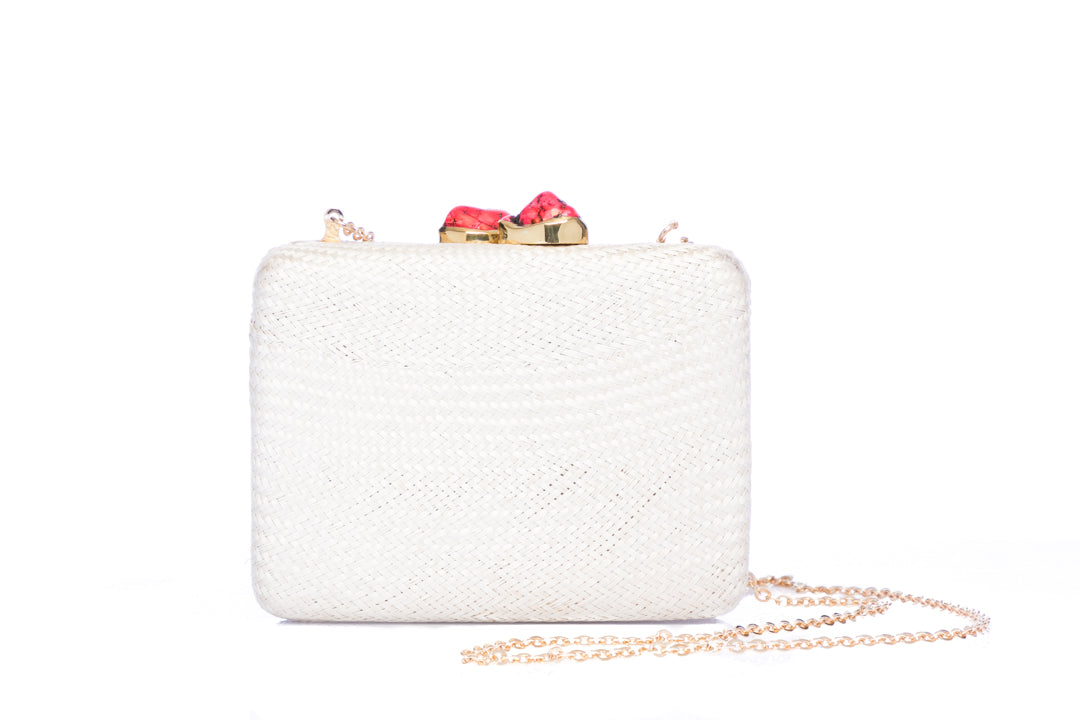Iris White Woven Clutch made from sustainable plant fibers, featuring a bold red stone accent, brass drop-in chain strap, and fully lined interior for an eco-friendly yet elegant look.
